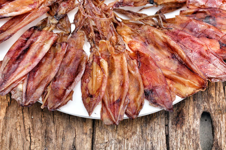 Dry squid on wood background