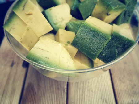 Avocado fruit on wood backgroundの写真素材