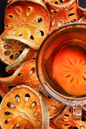Slices of dried bael fruit and teaの写真素材