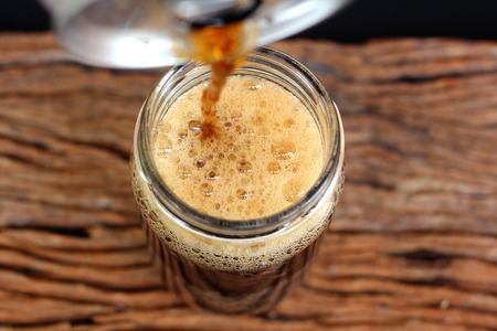 Pouring a glass of colaの写真素材