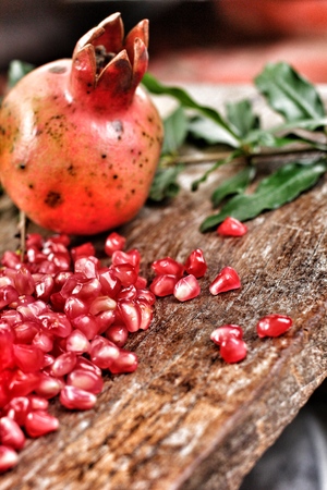 Pomegranate fruit on wood backgroundの写真素材