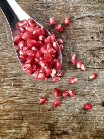 Pomegranate fruit on wood backgroundの写真素材