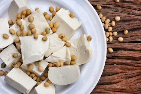 Soybeans and tofu on wood backgroundの写真素材