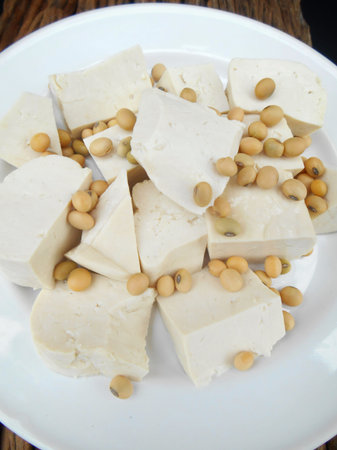 Soybeans and tofu on wood backgroundの写真素材