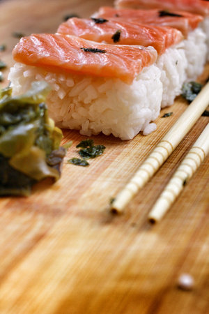 Salmon sushi on the wood backgroundの写真素材