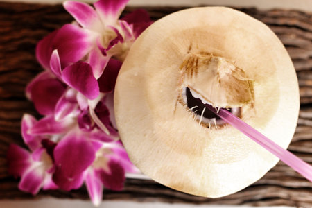 Coconut water drink and pink orchid