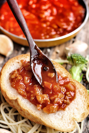 Spaghetti and tomato sauce with french breadの写真素材