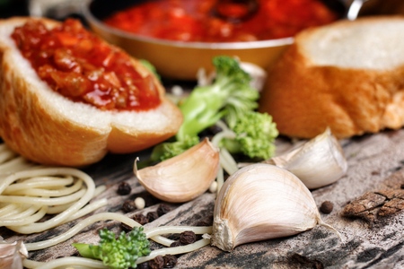 Spaghetti and tomato sauce with french breadの写真素材