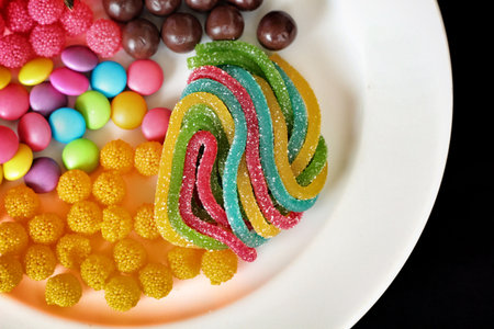 Mixed colorful candy on black background