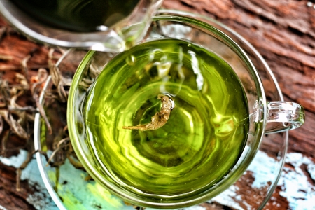 Cup with green tea on woodの写真素材