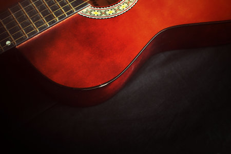 closeup of guitar on black background
