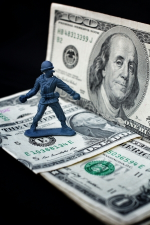 toy soldier and weapons standing with dollarの写真素材