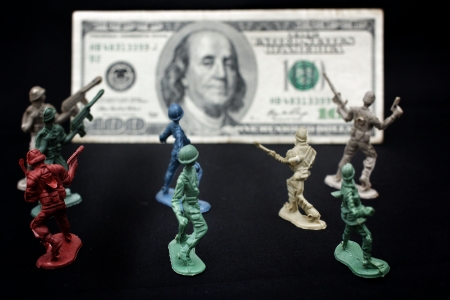 toy soldier and weapons standing with dollarの写真素材