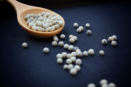 White pepper in wooden spoonの写真素材