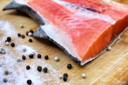 Fresh salmon with salt and pepperの写真素材