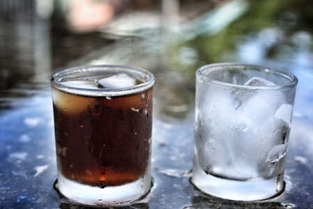 cola with ice cubes on black backgroundの写真素材