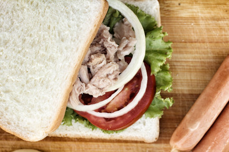 making tuna sandwich on cutting board