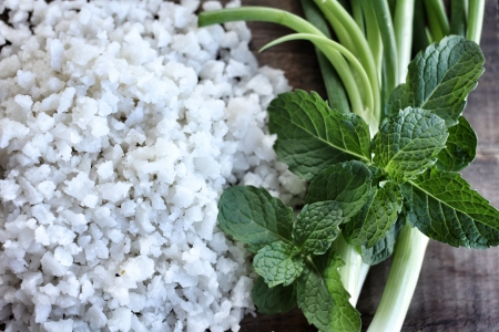 White sea salt and mint leaves.の写真素材