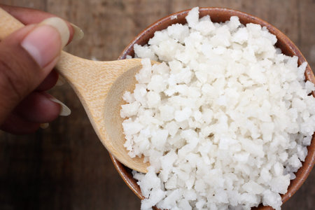 White sea salt on wood background