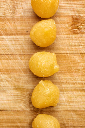 Gold egg yolks drops on wood background