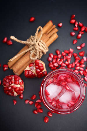 Red pomegranate juice in a glass cinnamonの写真素材