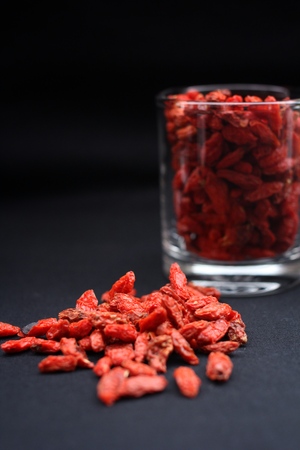 Red dried goji berries on black backgroundの写真素材