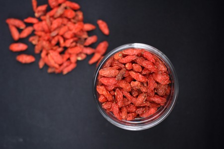 Red dried goji berries on black backgroundの写真素材