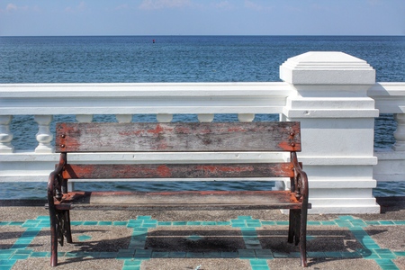 Wooden bench in front of the seaの写真素材