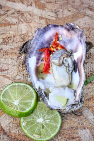 fresh raw oysters chilli and lemonの写真素材