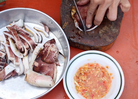 Squid grilled and sliced ââon a cutting boardの写真素材