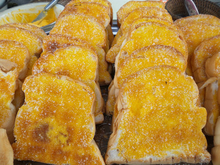 Toast with butter and sprinkling with sugar.