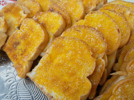 Toast with butter and sprinkling with sugar.
