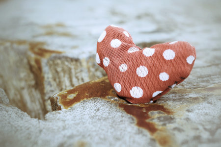 red fabric heart on wood for valentines dayの写真素材