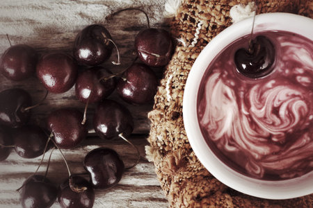 White yogurt and fresh cherries.の写真素材