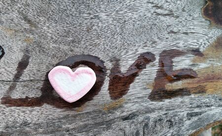 Marshmallows heart on wood background.の写真素材