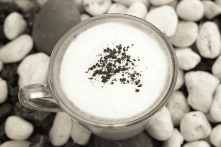 Cup with hot cappuccino on stoneの写真素材
