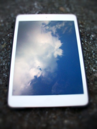 Tablet  touch with blue sky on black backgroundの写真素材