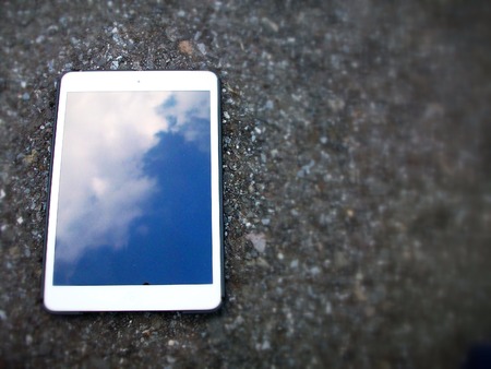 Tablet  touch with blue sky on black backgroundの写真素材