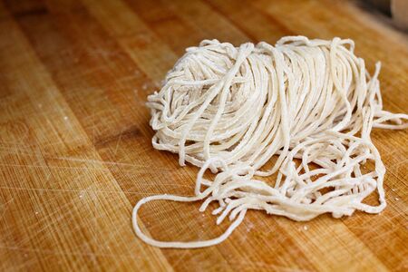Raw egg noodles and flourの写真素材