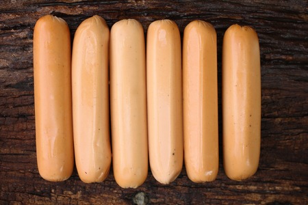 Sausages on the wood backgroundの写真素材