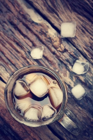 Glass of cola with ice cubes - vintage styleの写真素材