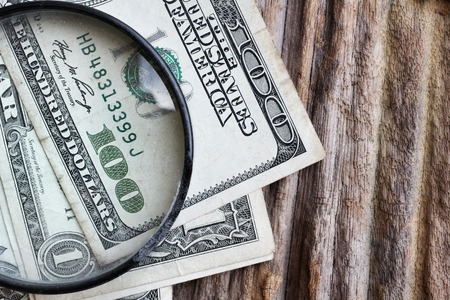 Magnifying glass on american dollars moneyの写真素材