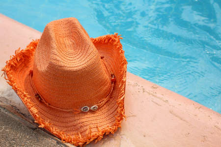 Hat on the swimming pool in summer dayの写真素材