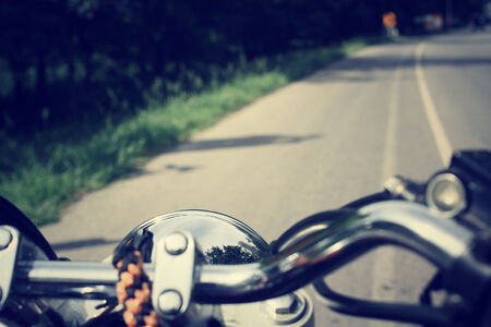 Driver riding motorcycle on the roadの写真素材