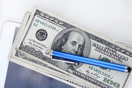 Dollar with pen and tablet computerの写真素材