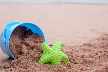 Children's beach toys on sandの写真素材