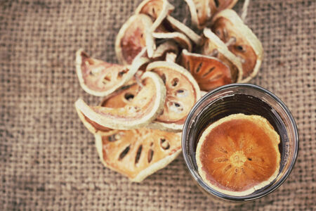 Slices of dried bael fruit and teaの写真素材