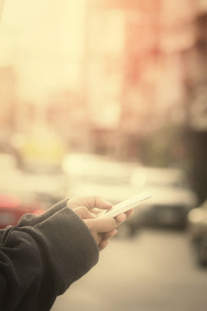 Using smart phone in the streetの写真素材