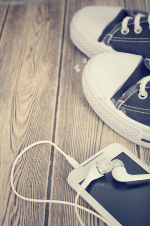 Sneakers vintage and smart phoneの写真素材