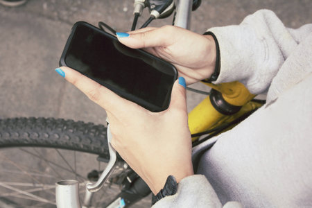 woman using smart phone on bikeの写真素材